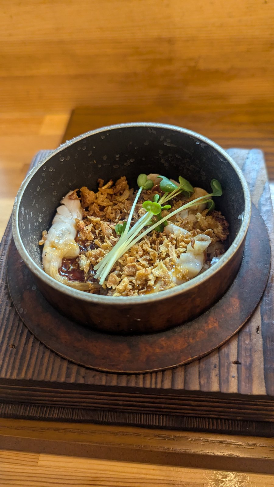 Close‑up of Kasho's pork rice bowl served in a small iron pot