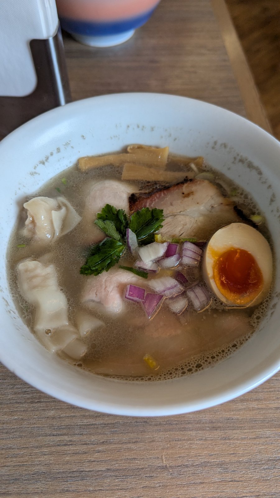 Signature ramen bowl at Chukasoba Waka with char siu, egg, mitsuba, and wontons
